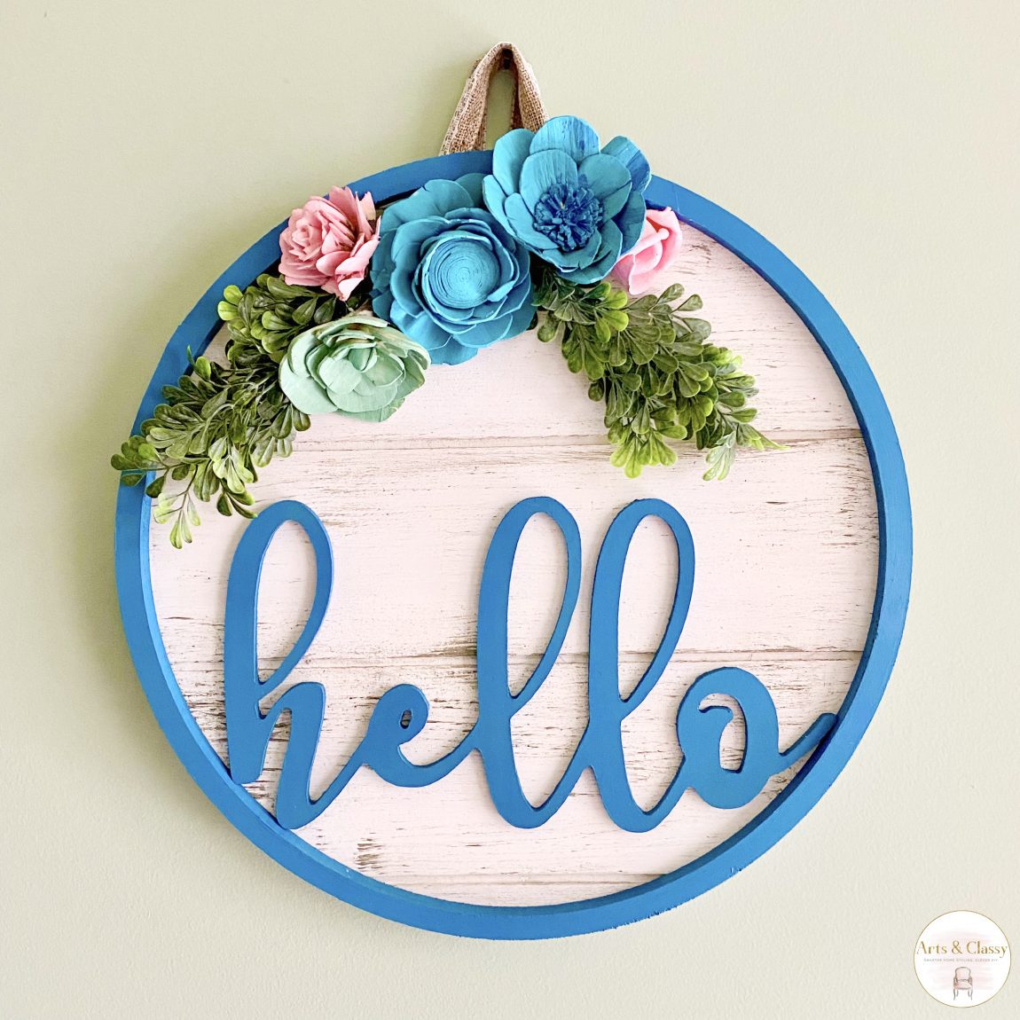 For springtime, why not add a little warmth to a home or office with a wood "Hello" door hanger? This cheerful decoration comes in bright colors and displays the timeless greeting in a bold and/or colorful font. 

It's easy to put up with just one nail or picture hanger and is sure to catch the eye of anyone who visits. These beautiful yet simple spring door decorations will make any home or office more inviting and welcoming, regardless if spring is in bloom or not.