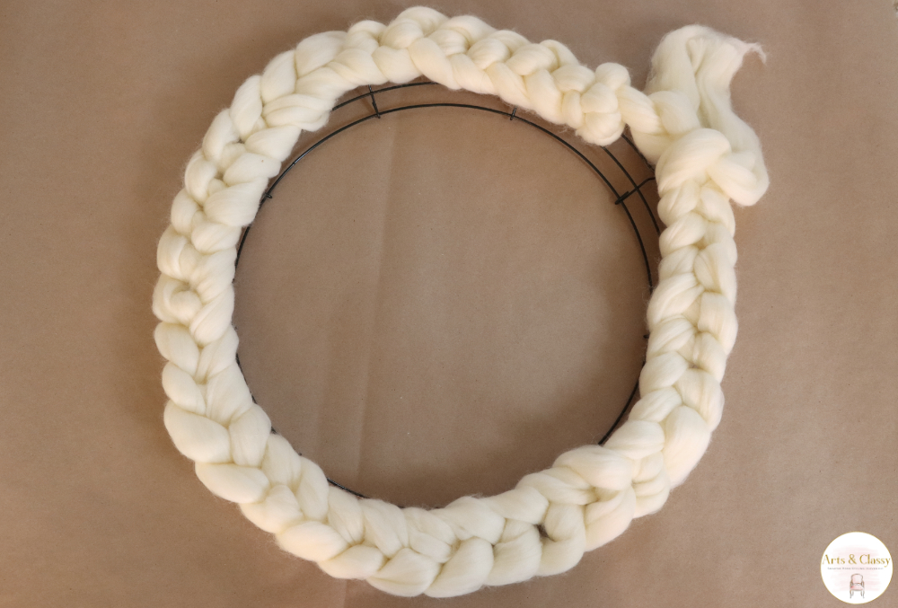 Looking to add a festive touch to your holiday decor? Look no further than this easy arm knitted wreath! This simple project can be completed in just an hour or two, and is a great way to use up any leftover yarn you may have. So grab some friends and get knitting!