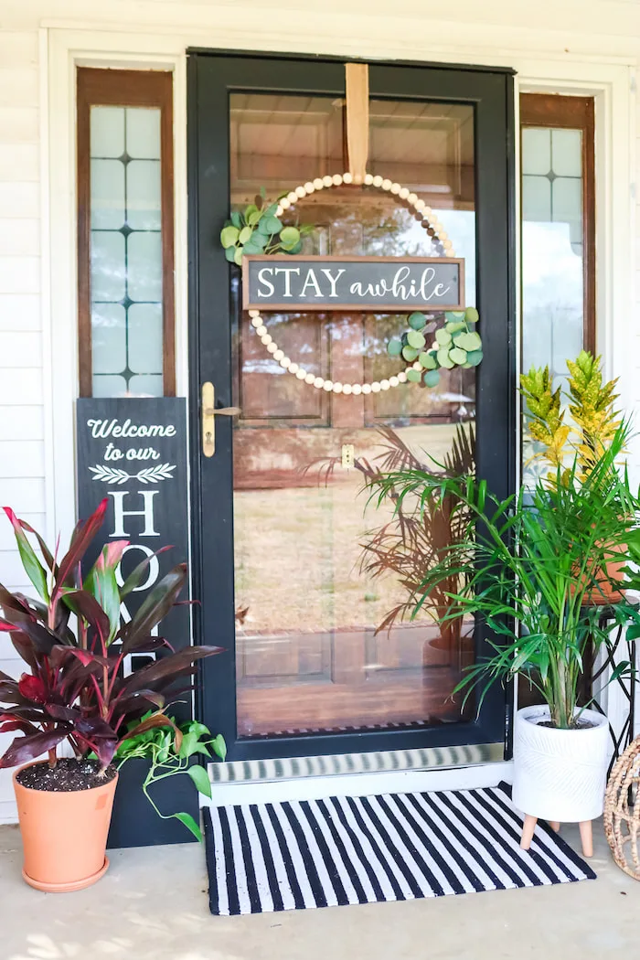 This spring, try incorporating flower pots and pot decor into your DIY front door decorations. Utilize a wreath hanger to hang two or three matching potted plants. Stand out from the crowd with some DIY wreath hanger door decorations. Challenge the traditional norms by changing out wreaths and add flower pots for a pop of color. 