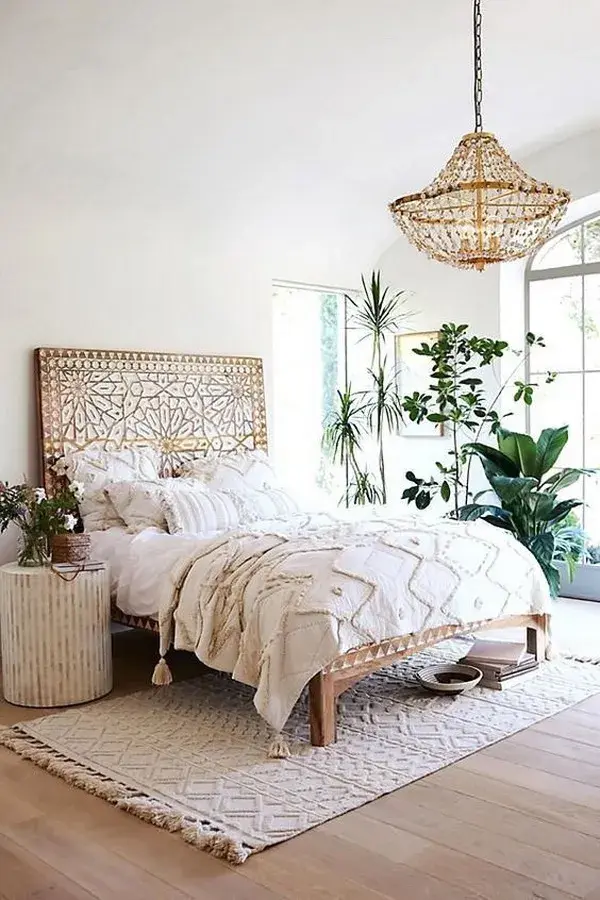 Serene bedroom adorned with cozy thrifted bedding and natural elements
