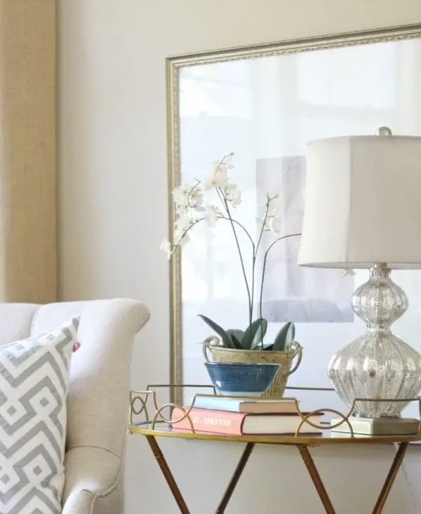 Stylish vignette on console table with books, vase, and art for an expensive-looking home setup